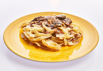  Plate of italian tagliatelle pasta with mushroom sauce isolated over white background