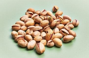  Bunch of pistachios over green background
