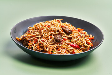  Plate of delicious noodles over green background