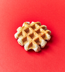 Single delicious waffle over red background