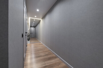 long empty corridor in interior of entrance hall of modern apartments, office or clinic