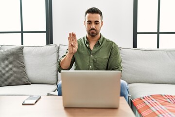 Young hispanic man having video call speaking with deaf language at home