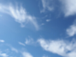 out of focus blue sky with clouds background