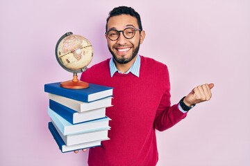 Hispanic man with beard geography teacher screaming proud, celebrating victory and success very...