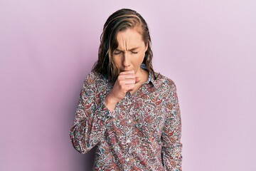 Young blonde woman wearing casual clothes feeling unwell and coughing as symptom for cold or...