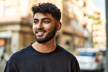 Young arab man smiling confident at street