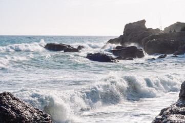 Sunset. Wild rock beach. The natural rock formation.