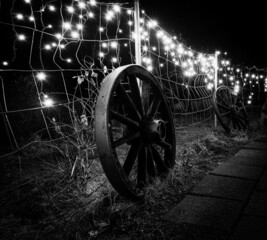 old wagon wheel in front of lights