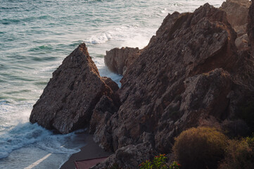 Sunset. Wild rock beach. The natural rock formation.