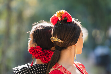 Close up view of the head of two women in flamenco traditional costume - obrazy, fototapety, plakaty