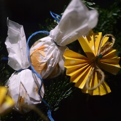 Wrapped gift on a hand-decorated spruce branch. Charming yellow paper bows and individually wrapped...