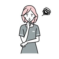 立って手をあごにあてて困っているエステ店員の女性