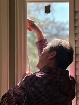 man measuring and installing lights