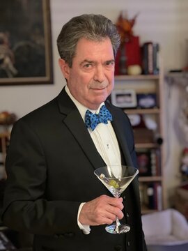 Man in black tie holding a martini
