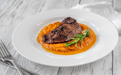 Beef steak with mashed pumpkin