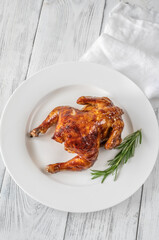 Roasted chicken on the white plate