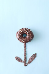 Donut isolated on a blue background. Surreal sweet food concept.