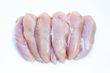 Raw chicken tenders on white background.