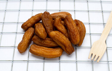 Sun-dried bananas on white background.