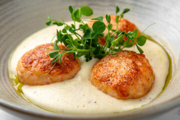 Children's meal in the restaurant. Turkey or chicken puree and cutlets in a festive plate on a marble background. Restaurant banquet menu.