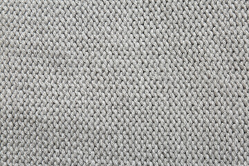 Beautiful grey knitted fabric as background, top view