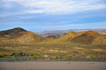 Mountains in the Gobi Desert in Xinjiang and poplar trees in the Tarim Basin in the desert taken during a tour bus ride
