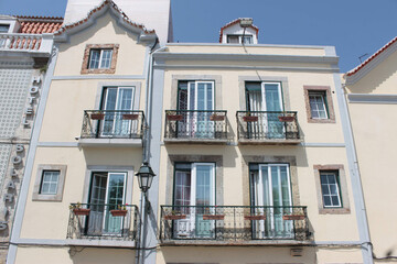 Facade of a building with metal and glass windows and iron balconies