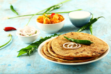 Aloo paratha - poato masala stuffed Indian flat bread served with fresh raita.