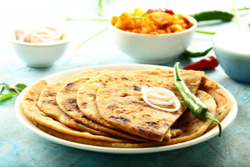 Punjabi dhaba style meal- aloo paratah with fresh raita and potato curry.