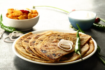North Indian wholesome meal- traditional aloo paratha with fresh raita and potato curry.