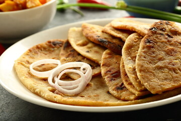 Punjabi dhaba style meal- aloo paratah with fresh raita and potato curry.