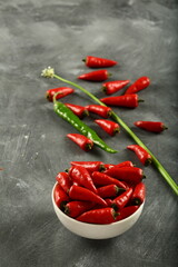 Bowl of fresh red organic chillies , paprika , spicy cooking ingredients,  