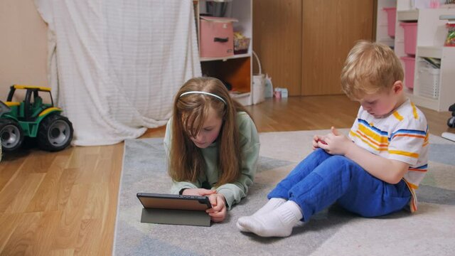 Child phone addiction girl and boy with gadgets