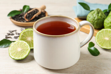 Cup of tasty bergamot tea on white wooden table - obrazy, fototapety, plakaty