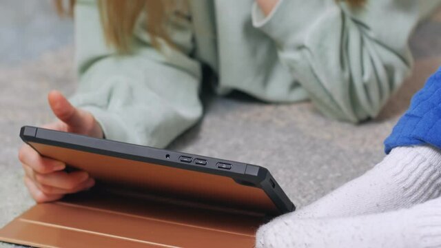 Girl playing on gadget closeup