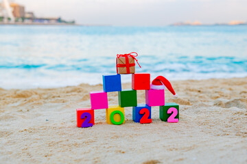 numbers 2022 and colored cubes with a New Year's gift