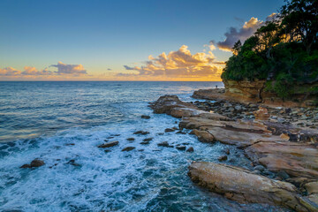 Aerial sunrise over the sea with clouds