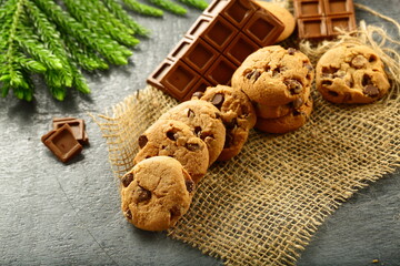 Homemade delicious fresh baked chocolate chip cookies on a rustic background.