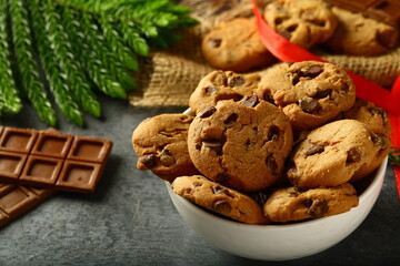Homemade vegan chocolate chip cookies on  holiday background.
