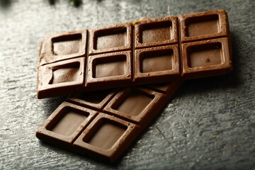 Healthy organic chocolate bars on a rustic wooden table.