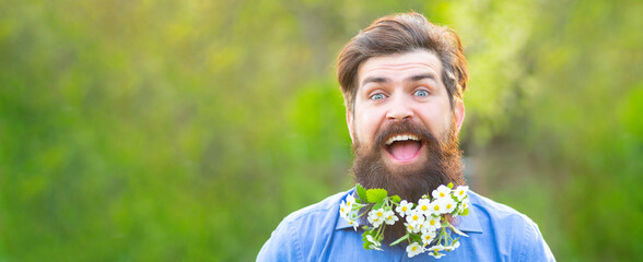 Spring banner of man outdoor. Blossom beard. Funny head portrait of a bearded man looking at the...