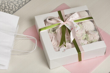 Homemade marshmallow in a gift box. Tied with a ribbon tied to a bow. On a white background....