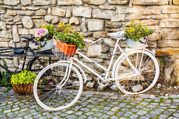 Fototapeta na wymiar Beautiful And Famous Street Decorated With Old Bikes With Flower Baskets. Sighișoara, Romania. Europe. Travel Concept. Summer Day