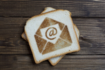 toast with email sign on dark wood.