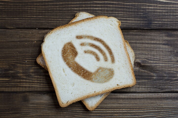 toast with an incoming call sign on dark wood.