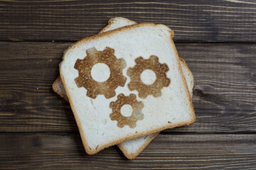 toast with a working gears sign on dark wood.