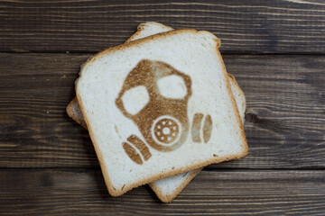 toast with gas mask sign on dark wood.