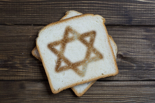 toast with the sign of the Jewish star on dark wood.