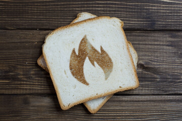 toast with a fire sign on dark wood.