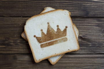 toast with the crown sign on dark wood.